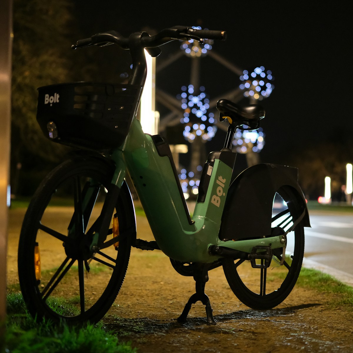 a green bike parked on the side of a road
